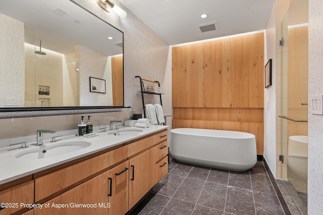 bathroom with vanity and independent shower and bath