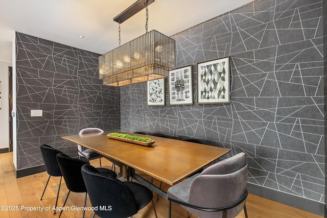 dining room with tile walls and light hardwood / wood-style floors