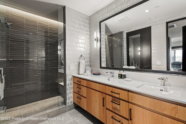 bathroom with vanity, tile patterned flooring, and a shower with door