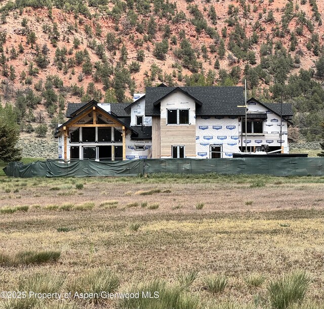 65 Upland Ln Unit 2, Carbondale, CO 81623 - rear view of property featuring a lawn and a shingled roof