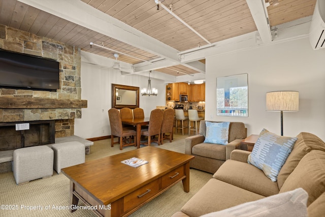 610 S W End St Unit H202, Aspen, CO 81611 - living area with a chandelier, a wall mounted air conditioner, light carpet, a wooden ceiling with exposed beams, and a stone fireplace