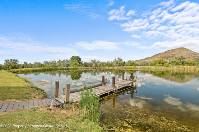 view of dock featuring a water and mountain view