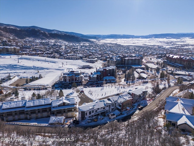 snowy aerial view with a mountain view