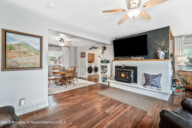 235 W 8th St, Craig, CO 81625 - living area with separate washer and dryer, ceiling fan, wood finished floors, and a lit fireplace
