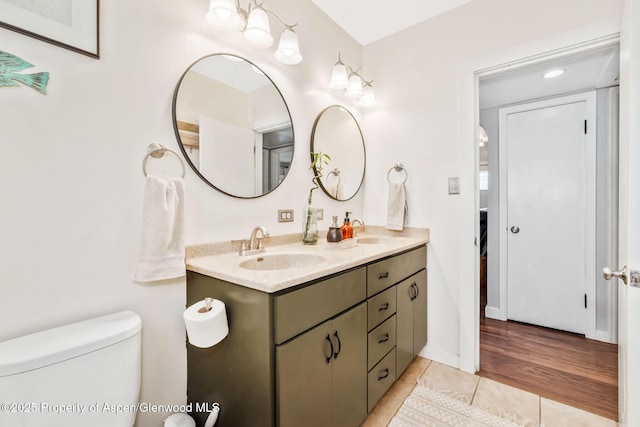 235 W 8th St, Craig, CO 81625 - full bath featuring double vanity, tile patterned floors, toilet, and baseboards