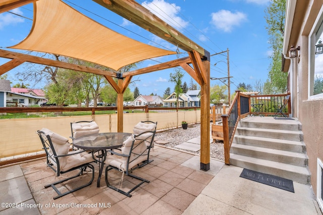 235 W 8th St, Craig, CO 81625 - view of patio / terrace featuring fence, outdoor dining area, and a residential view