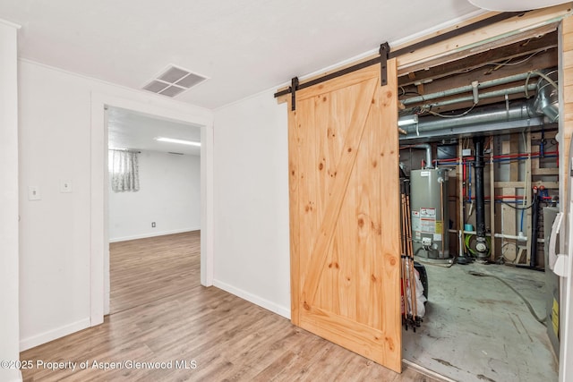 235 W 8th St, Craig, CO 81625 - basement with water heater, wood finished floors, baseboards, and a barn door
