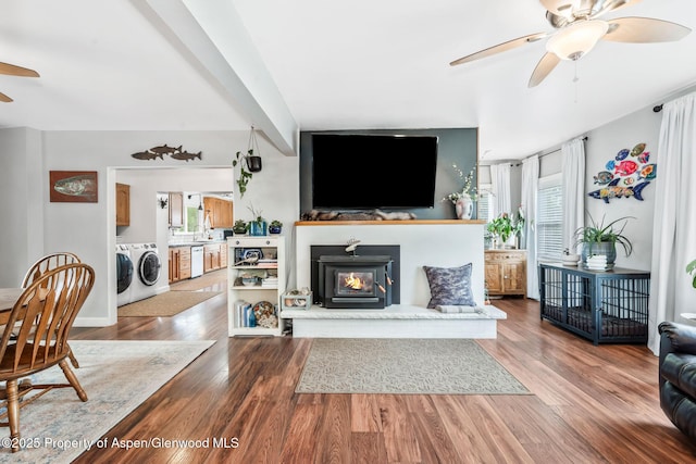 235 W 8th St, Craig, CO 81625 - living area with ceiling fan, washing machine and dryer, wood finished floors, and a glass covered fireplace