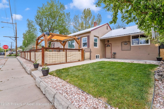 235 W 8th St, Craig, CO 81625 - view of front facade featuring stucco siding, a chimney, and metal roof