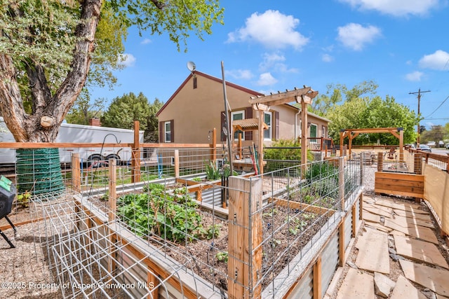 235 W 8th St, Craig, CO 81625 - back of property featuring a vegetable garden, stucco siding, and fence