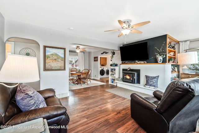 235 W 8th St, Craig, CO 81625 - living room with washing machine and clothes dryer, ceiling fan, wood finished floors, baseboards, and a warm lit fireplace