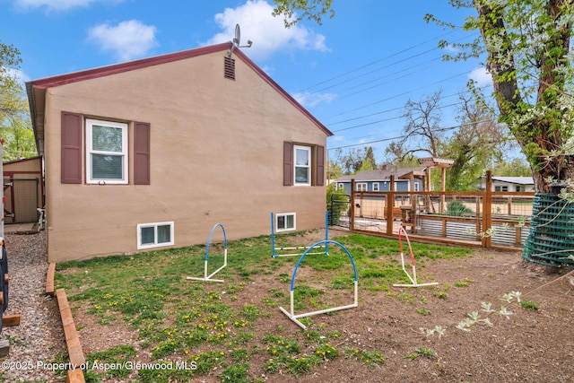 235 W 8th St, Craig, CO 81625 - view of side of home featuring fence and stucco siding