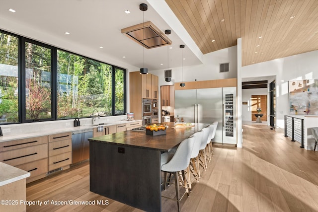 1234 Wood Rd, Snowmass Village, CO 81615 - kitchen featuring modern cabinets, appliances with stainless steel finishes, light brown cabinetry, a center island, and recessed lighting