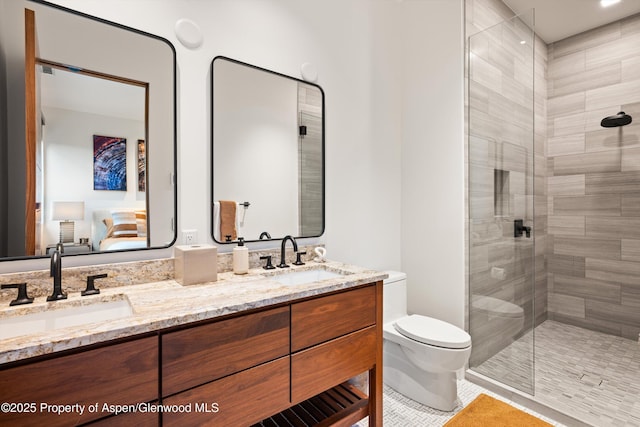 1234 Wood Rd, Snowmass Village, CO 81615 - ensuite bathroom featuring toilet, double vanity, a tile shower, and tile patterned flooring