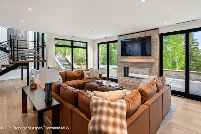 1234 Wood Rd, Snowmass Village, CO 81615 - living room with stairs, healthy amount of natural light, a stone fireplace, light wood-style flooring, and recessed lighting