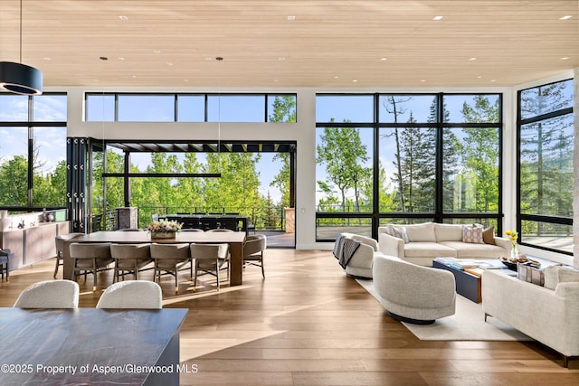 1234 Wood Rd, Snowmass Village, CO 81615 - sunroom featuring wood ceiling, hardwood / wood-style floors, plenty of natural light, recessed lighting, and a wall of windows