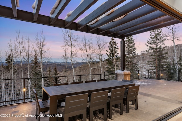 1234 Wood Rd, Snowmass Village, CO 81615 - patio terrace at dusk with outdoor dining space, a mountain view, and a patio area