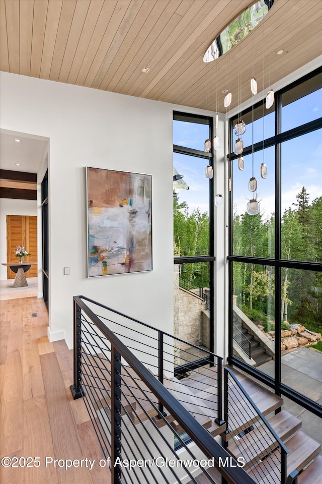 1234 Wood Rd, Snowmass Village, CO 81615 - corridor featuring expansive windows, hardwood / wood-style floors, an upstairs landing, and recessed lighting