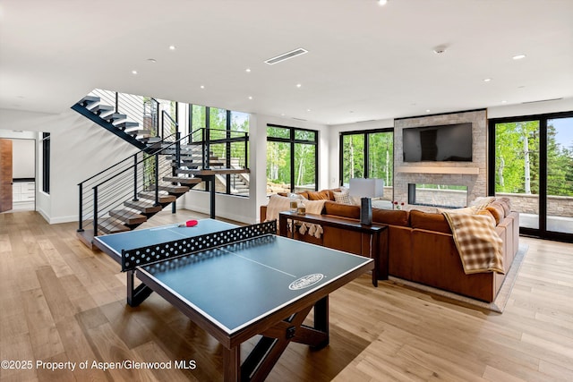 1234 Wood Rd, Snowmass Village, CO 81615 - rec room featuring plenty of natural light, light wood-style flooring, recessed lighting, a multi sided fireplace, and baseboards