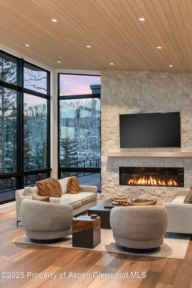 1234 Wood Rd, Snowmass Village, CO 81615 - living room with wooden ceiling, a stone fireplace, wood finished floors, expansive windows, and recessed lighting