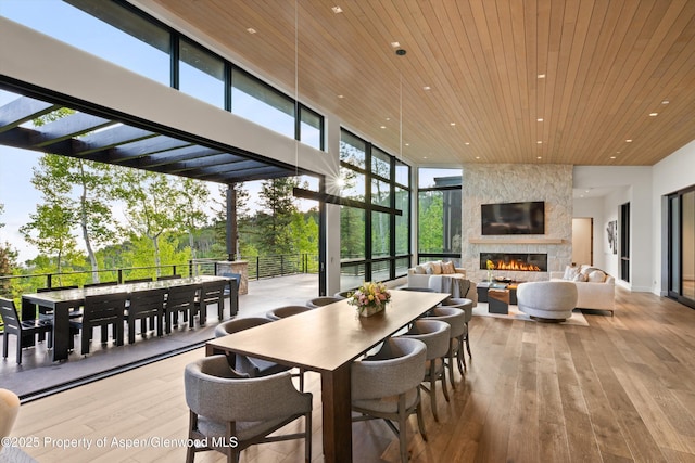 1234 Wood Rd, Snowmass Village, CO 81615 - dining area featuring wooden ceiling, recessed lighting, a large fireplace, hardwood / wood-style floors, and a towering ceiling