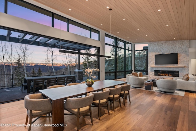 1234 Wood Rd, Snowmass Village, CO 81615 - dining space with wooden ceiling, recessed lighting, hardwood / wood-style flooring, floor to ceiling windows, and a fireplace