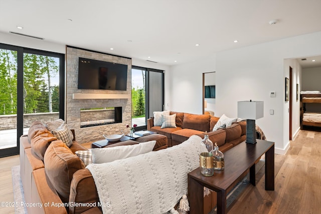 1234 Wood Rd, Snowmass Village, CO 81615 - living room with plenty of natural light, light wood-style floors, a fireplace, recessed lighting, and baseboards