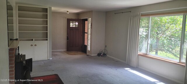 888 Pershing St, Craig, CO 81625 - unfurnished living room featuring carpet floors and plenty of natural light