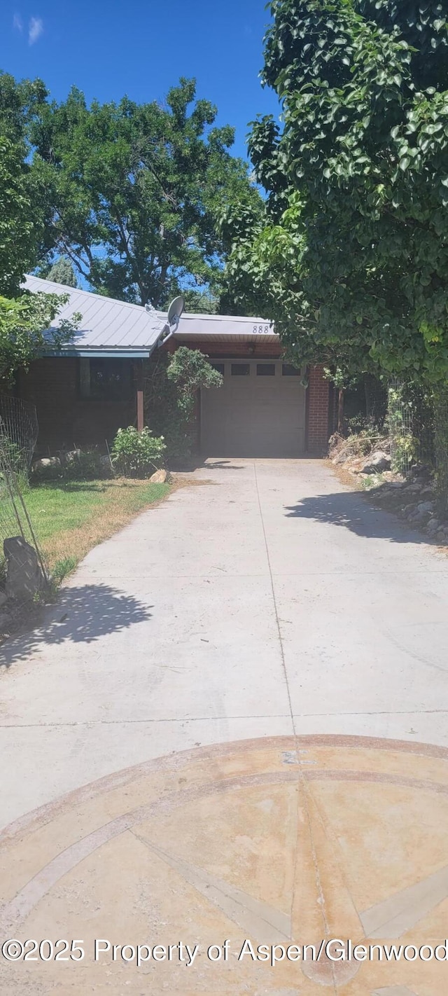 888 Pershing St, Craig, CO 81625 - view of front of home featuring concrete driveway and a carport