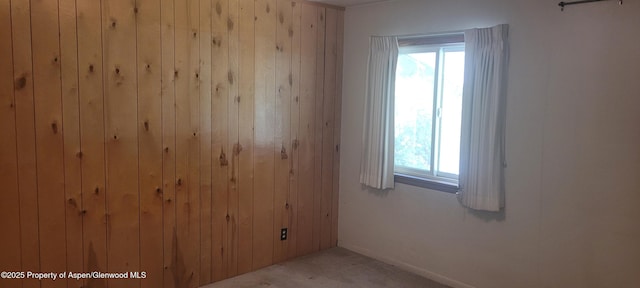 888 Pershing St, Craig, CO 81625 - carpeted empty room featuring wooden walls and healthy amount of natural light