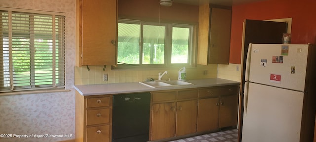 888 Pershing St, Craig, CO 81625 - kitchen with freestanding refrigerator, black dishwasher, light countertops, and tasteful backsplash