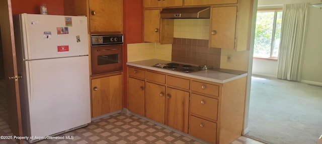 888 Pershing St, Craig, CO 81625 - kitchen featuring freestanding refrigerator, oven, stainless steel electric cooktop, light countertops, and under cabinet range hood