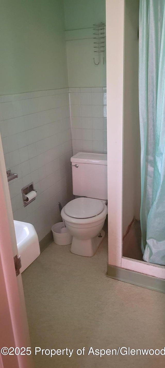 888 Pershing St, Craig, CO 81625 - full bathroom with a stall shower and tile walls