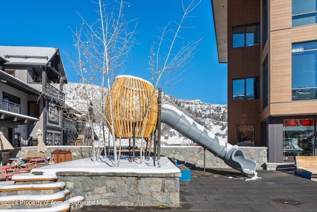 exterior space with a mountain view and a playground