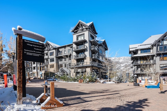 snow covered property with a mountain view