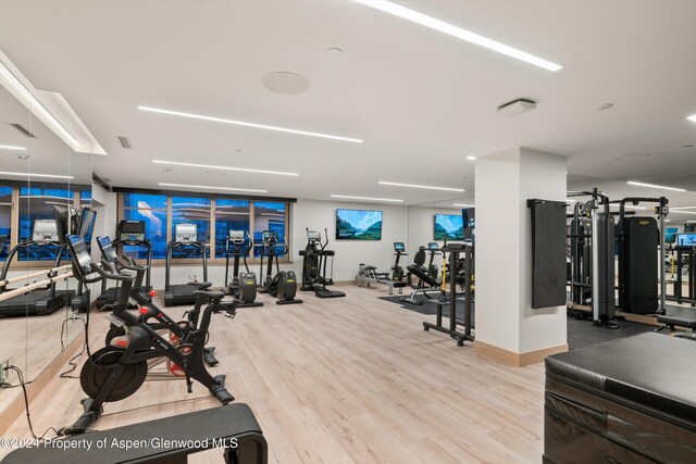 gym with light hardwood / wood-style floors