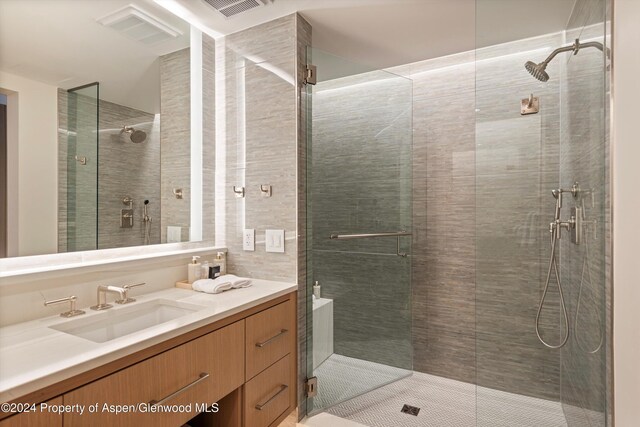 bathroom featuring vanity and a shower with door