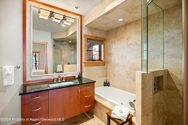 bathroom featuring vanity and independent shower and bath