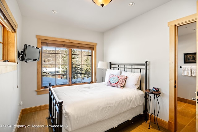 bedroom with hardwood / wood-style flooring