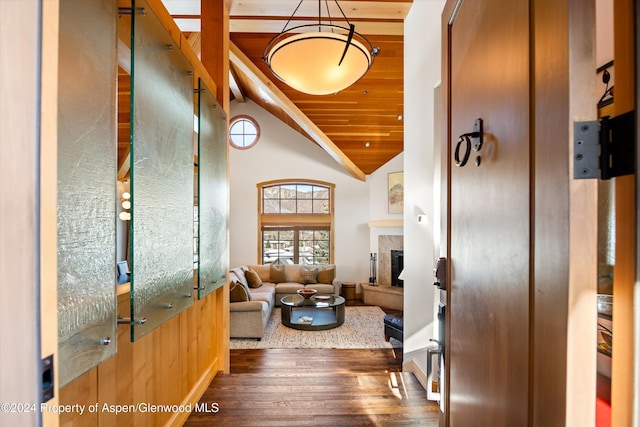 living room featuring hardwood / wood-style flooring, high vaulted ceiling, wood walls, and wood ceiling