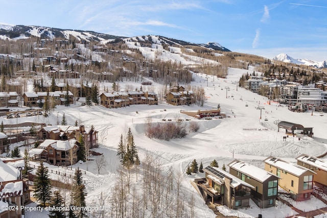 snowy aerial view with a mountain view