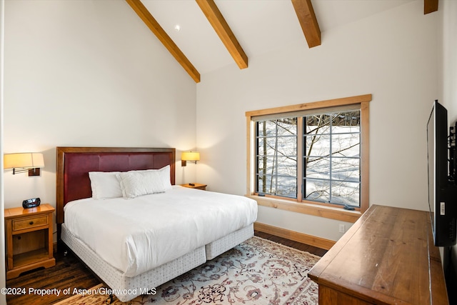 bedroom with beamed ceiling, dark hardwood / wood-style floors, and high vaulted ceiling