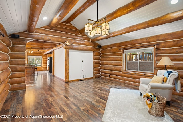 unfurnished living room with vaulted ceiling with beams, wood-type flooring, and log walls