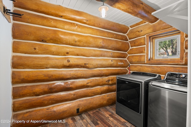 laundry room featuring separate washer and dryer, dark hardwood / wood-style flooring, and log walls