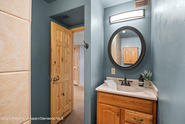 bathroom with tile patterned floors and vanity