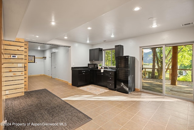 kitchen with sink and light tile patterned flooring