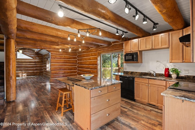 kitchen with rustic walls, sink, black appliances, beam ceiling, and a kitchen island