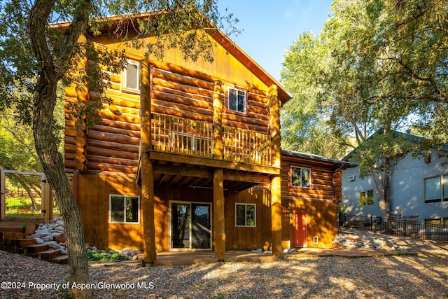 rear view of property with a wooden deck