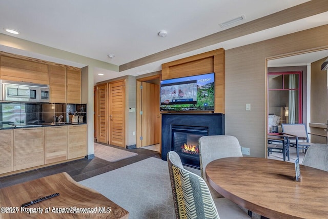 130 Wood Rd Unit 625, Snowmass Village, CO 81615 - dining room featuring a glass covered fireplace, recessed lighting, and dark tile patterned floors