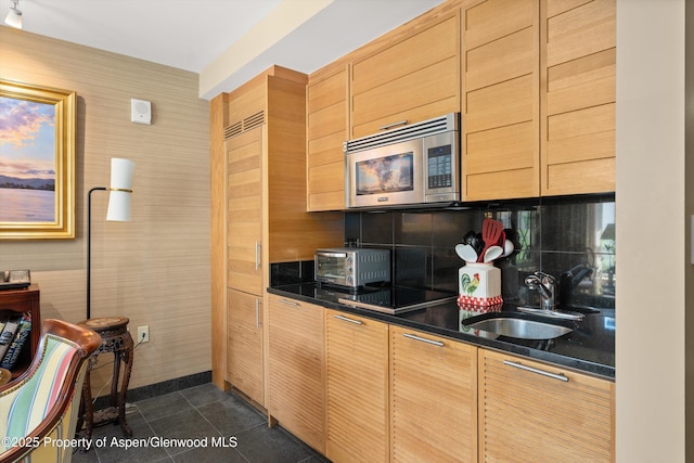 130 Wood Rd Unit 625, Snowmass Village, CO 81615 - kitchen featuring stainless steel microwave, backsplash, dark tile patterned flooring, black electric cooktop, and light brown cabinetry